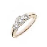 Three stone diamond ring, the white mount stamped '18k', the graduated brilliant cuts measuring