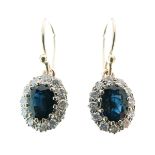 Pair of sapphire and diamond oval cluster drop earrings, the oval cut sapphires measuring