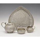 Indian white metal four piece tea service comprising: globular teapot, the hinged cover with