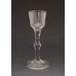 18th Century wine glass having an ogee bowl, plain stem with central knop and standing on a circular