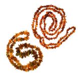 Row of graduated tumbled amber beads, with a long row of small tumbled amber beads, approximately