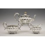 William IV/Edward VII silver three piece tea set, each piece of lobed form and standing on four