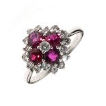 Diamond and ruby cluster ring, stamped '18ct' and 'Plat', the four round cut rubies enclosing a