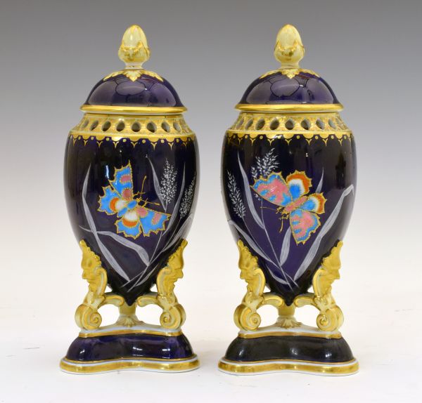 Pair of 19th Century porcelain urn shaped pot pourri and covers, each decorated in polychrome