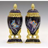 Pair of 19th Century porcelain urn shaped pot pourri and covers, each decorated in polychrome