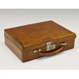 Early 20th Century crocodile leather travelling stationery case, the hinged cover and front panel