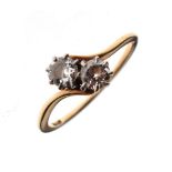 Two stone diamond ring of crossover design, the shank stamped 18ct, size O, 2.2g gross approx