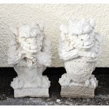 Pair of reconstituted gargoyles, one holding a sword, the other a shield, each 38cm high Condition: