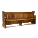 Late 19th/early 20th Century carved oak pew of double-ended design with lancet arch panels to sides,