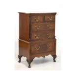 Old reproduction mahogany chest on stand of small proportions, the upper section having a