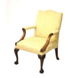 Old reproduction Georgian style mahogany framed Gainsborough chair, the outswept arms with carved