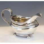 William IV silver helmet shaped cream jug having an acanthus scroll handle, gadrooned rim and