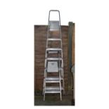 Two aluminium folding ladders, the larger of six treads marked Titan (2) Condition: