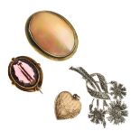 Three various brooches and a gold plated locket Condition: