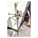 Wrought iron weather vane surmounted by a cockerel over scroll work and compass points on box