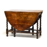 Early 20th Century oak gateleg dining table with oval flaps on barley twist supports Condition: