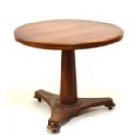 Victorian mahogany circular breakfast table standing on a tapered octagonal pillar and triform base,
