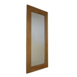 Modern wooden-framed wall mirror with plain rectangular plate Condition: