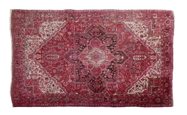 20th Century Persian wool carpet, the red field with central flower head medallion within further