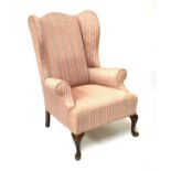 Georgian style wing back library chair upholstered in striped fabric and standing on cabriole