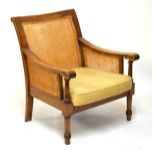 Hardwood framed bergere chair having double back and side panels, scroll arms supported by turned