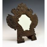 Continental embossed leather dressing table mirror, the shield shaped plate within a surround of