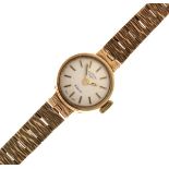Lady's 9ct gold Rotary cocktail watch, the champagne dial with baton markers, on a textured