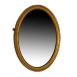 Early 20th Century gilt-framed oval wall mirror having a bevelled plate within gadrooned surround,