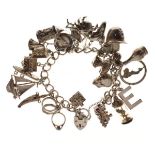 Charm bracelet with silver and other charms, 87g approx Condition: