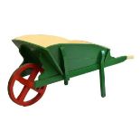 Vintage green and cream-painted wooden wheelbarrow with red-painted four spoke iron-bound wheel,