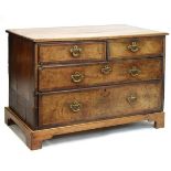 18th Century walnut-veneered chest of two short and two long drawers with brass handles beneath