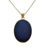 Oval pendant set lapis lazuli within 9ct gold frame, with a fine chain Condition: