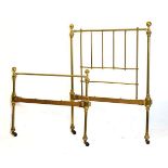 Early 20th Century brass-framed single bed retailed by Maple & Co., of tubular design with ball