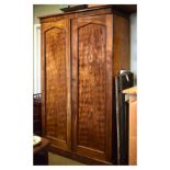 Victorian mahogany two door wardrobe, the doors opening to reveal a partially fitted interior with