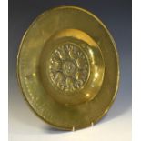Nuremberg style brass alms dish, 19th Century, having typical embossed decoration to the centre