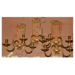Set of three gilt metal twin branch wall sconces, each with lattice back and pair of shades
