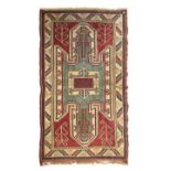 Modern Caucasian style wool rug having geometric decoration on a red ground within multi borders,