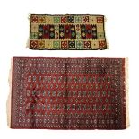 Modern Turkoman style rug typically decorated with rosettes on a red ground within multi borders,