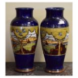 Pair of Doulton Lambeth stoneware vases, each having a band on continuous decoration depicting a