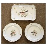 Two Meissen porcelain plates, each centrally decorated with a bird within a moulded border decorated