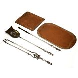 Good quality three piece steel fireside companion set, together with two embossed copper trays