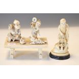 Late 19th/early 20th Century ivory okimono depicting figures on a table, together with a figure of a