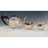 Edward VII silver three piece tea service of oval design with reeded lower body, Sheffield 1904