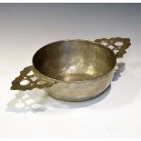 Old reproduction pewter two handled porringer, the handles with typical pierced decoration, initials