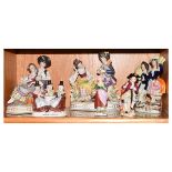 Pair of 20th Century German porcelain figure groups, each depicting a musician and his sweetheart on