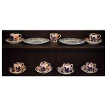 Six 19th Century English porcelain coffee cans and saucers decorated in the Imari pallet, together