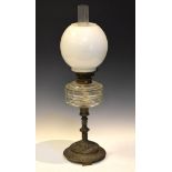 Late 19th Century paraffin lamp with opaque shade and clear reservoir on cast stepped circular base,