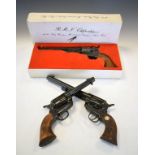 Three replica pistols including a Navy revolver, single action Army 45 and one other pistol