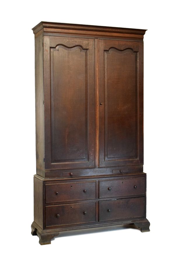 George III oak linen press, the upper stage with moulded cornice and arch-panelled doors enclosing