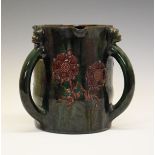 Elton Ware tyg, each loop handle with a mask head capital, decorated with stylised foliage on a